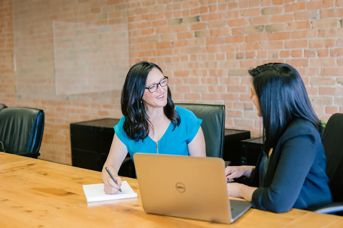 Two business professionals discussing a project at a table