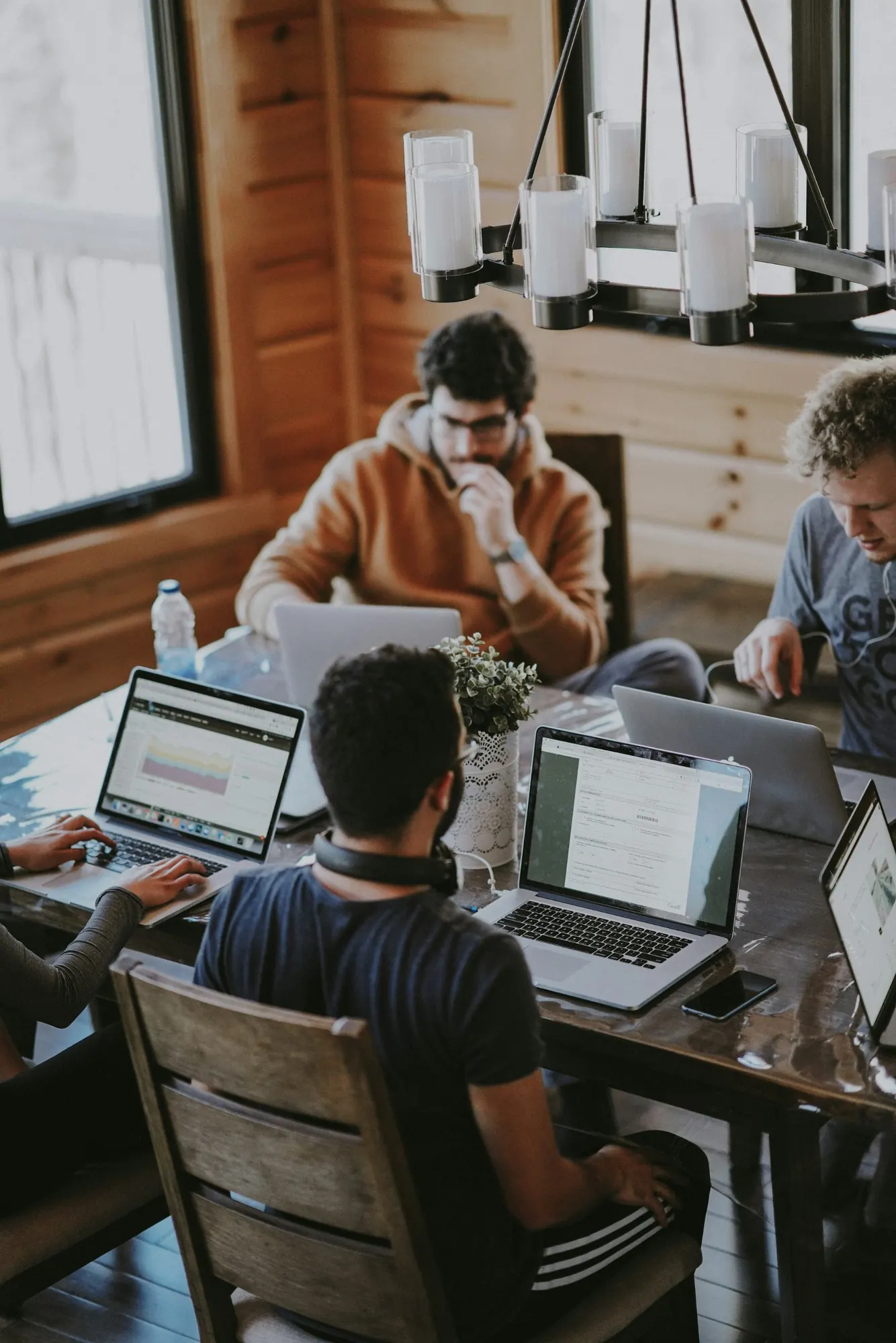 A diverse professional technology team collaborating in a modern workspace