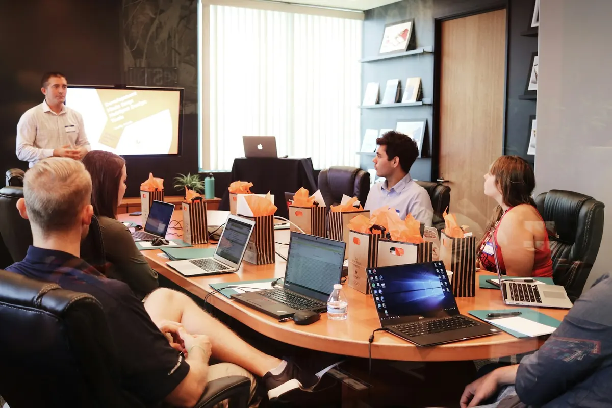 Senior professionals collaborating around a table on a technology project